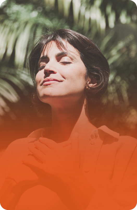 Mulher com expressão serena e olhos fechados, com fundo vermelho intenso.